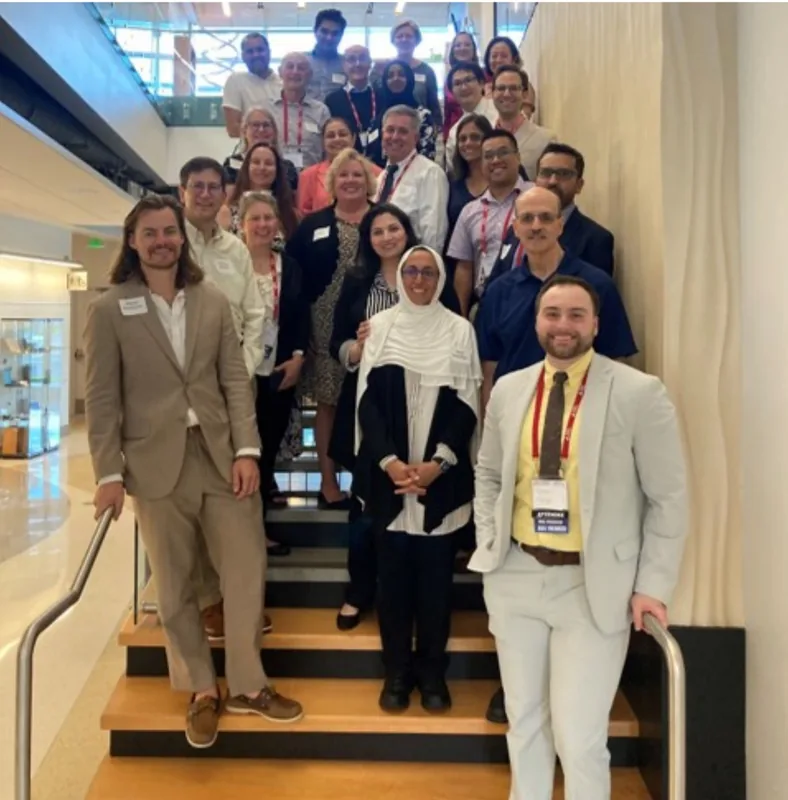 The JCHR team gathered on a staircase at a conference